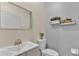 Stylish powder room features a modern sink with metallic faucet, toilet, and decorative shelving at 1056 Royal Saint George Dr, Orlando, FL 32828