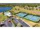 Aerial view of community tennis courts, swimming pool, and clubhouse at 1056 Royal Saint George Dr, Orlando, FL 32828
