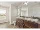 Bright bathroom features a double sink vanity, marble countertops and a window letting in plenty of natural light at 2257 Pecos Ct, Kissimmee, FL 34759