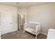 A charming bedroom with a bright, neutral color scheme and a stylish crib, creating a serene and inviting space at 2257 Pecos Ct, Kissimmee, FL 34759