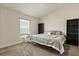 Comfortable bedroom with large window, neutral walls, plush carpeting, and a full sized bed at 2257 Pecos Ct, Kissimmee, FL 34759