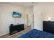 Well-lit bedroom with large TV, ample closet space, and plush carpet at 2257 Pecos Ct, Kissimmee, FL 34759