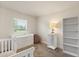 Cozy bedroom featuring neutral decor, a dresser and white shelving for ample storage and soft natural light from the window at 2257 Pecos Ct, Kissimmee, FL 34759