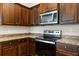Stylish kitchen features stainless steel appliances, sleek countertops and dark cabinets at 2257 Pecos Ct, Kissimmee, FL 34759