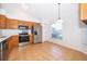 Eat-in kitchen features stainless steel appliances, wood cabinets, tile floors, and large window at 2637 Shelby Ruth Pl, St Cloud, FL 34769