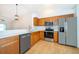Kitchen with stainless steel appliances, wood cabinets, breakfast bar, and pendant lighting at 2637 Shelby Ruth Pl, St Cloud, FL 34769
