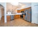 Kitchen features stainless steel appliances, wood cabinets, tile floors, and views to the living area at 2637 Shelby Ruth Pl, St Cloud, FL 34769