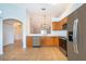 Kitchen with stainless steel appliances, breakfast bar, and arched entrance to living area at 2637 Shelby Ruth Pl, St Cloud, FL 34769