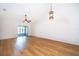 Unfurnished living room with vaulted ceilings, wood floors, and access to the patio at 2637 Shelby Ruth Pl, St Cloud, FL 34769