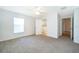 Bright main bedroom with carpet, ceiling fan, and private bathroom entrance at 2637 Shelby Ruth Pl, St Cloud, FL 34769