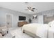 Bedroom featuring a ceiling fan, neutral color palette, and an ensuite bathroom with a glass-enclosed shower at 2661 Estuary Loop, Oviedo, FL 32765