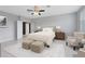 A serene main bedroom boasts an upholstered headboard, side tables, and a comfy chair with footstool at 2661 Estuary Loop, Oviedo, FL 32765