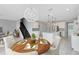 Dining area next to an open kitchen, featuring a chandelier and a wooden table with dining setting at 2661 Estuary Loop, Oviedo, FL 32765