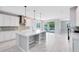 Bright, open kitchen features an island, stainless steel appliances and sliding glass doors to the backyard at 2661 Estuary Loop, Oviedo, FL 32765