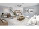 Open-concept living room with ample seating and decor, flowing seamlessly into the dining area and kitchen at 2661 Estuary Loop, Oviedo, FL 32765