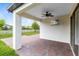 Covered brick patio with a ceiling fan, overlooking the backyard and a view of the lake at 2661 Estuary Loop, Oviedo, FL 32765