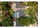 Aerial view of a home with a screened-in pool, patio area, well-manicured lawn, and mature trees surrounding the property at 878 W Timberland Trl, Altamonte Springs, FL 32714