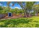 Spacious backyard featuring a storage shed, mature trees, and well-maintained lawn, offering a serene outdoor space at 878 W Timberland Trl, Altamonte Springs, FL 32714