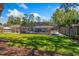 Expansive backyard featuring a screened-in pool, lush lawn, mature trees, and a privacy fence, perfect for outdoor enjoyment at 878 W Timberland Trl, Altamonte Springs, FL 32714