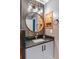 Bathroom vanity with a round mirror, cabinet storage, and gray countertop at 878 W Timberland Trl, Altamonte Springs, FL 32714