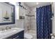 Nautical-themed bathroom featuring a vanity with blue accents and shower with anchor curtains at 878 W Timberland Trl, Altamonte Springs, FL 32714