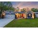 Inviting single-story home showcasing exterior lighting and a well-maintained front yard at 878 W Timberland Trl, Altamonte Springs, FL 32714