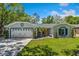 Inviting single-story home featuring a well-manicured lawn and a spacious two car garage at 878 W Timberland Trl, Altamonte Springs, FL 32714