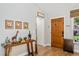 Bright foyer showcasing hardwood floors, decorative table, and solid wood door at 878 W Timberland Trl, Altamonte Springs, FL 32714