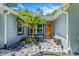 Home's entry featuring a unique stone pathway, decorative plants, and bench at 878 W Timberland Trl, Altamonte Springs, FL 32714