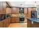 Well-appointed kitchen boasts wooden cabinets, stainless steel appliances, stone backsplash and plenty of counter space at 878 W Timberland Trl, Altamonte Springs, FL 32714