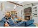 Bright living room featuring vaulted ceiling with skylights, wood beam, stone fireplace, and hardwood flooring at 878 W Timberland Trl, Altamonte Springs, FL 32714