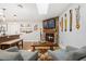 Comfortable living room with stone fireplace, wooden floors, African-themed decor, and a view of kitchen at 878 W Timberland Trl, Altamonte Springs, FL 32714