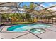 Screened-in pool with a spa, patio area, and lush backyard at 878 W Timberland Trl, Altamonte Springs, FL 32714