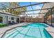 Sparkling screened-in pool with tiled trim, surrounded by lounge chairs, outdoor seating, and a well-maintained patio at 878 W Timberland Trl, Altamonte Springs, FL 32714