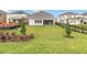 Expansive backyard with lush green grass, landscaped features, and a screened-in patio visible on the home at 12805 Charmed Dr, Winter Garden, FL 34787