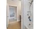 Close-up of a bright white tiled shower with modern fixtures and neutral colored floor tile at 12805 Charmed Dr, Winter Garden, FL 34787