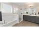 Beautiful bathroom featuring a soaking tub, separate glass shower, and modern double sink vanity at 12805 Charmed Dr, Winter Garden, FL 34787