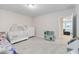 Neutral bedroom with a crib, a white dresser and a kitchen at 12805 Charmed Dr, Winter Garden, FL 34787