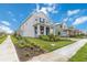 Charming two-story home with a covered porch and a well-manicured front lawn at 12805 Charmed Dr, Winter Garden, FL 34787