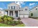 Charming two-story home with brick driveway, two-car garage, and manicured landscaping at 12805 Charmed Dr, Winter Garden, FL 34787
