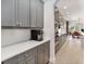 Open kitchen area featuring gray cabinetry, stainless steel appliances, and a view to the dining area at 12805 Charmed Dr, Winter Garden, FL 34787