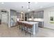 Modern kitchen with gray cabinets, a large center island, and stainless-steel appliances at 12805 Charmed Dr, Winter Garden, FL 34787