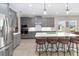 Modern kitchen with gray cabinets, a large center island, and stainless-steel appliances at 12805 Charmed Dr, Winter Garden, FL 34787