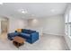 Bright living room with plush blue sofa and modern wood coffee table at 12805 Charmed Dr, Winter Garden, FL 34787