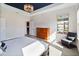 Airy main bedroom with tray ceilings, stylish chandelier, and comfortable sitting area by the window at 12805 Charmed Dr, Winter Garden, FL 34787