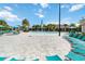 Stunning community pool area with lounge chairs, umbrellas, and a central water fountain feature at 12805 Charmed Dr, Winter Garden, FL 34787