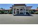 Building entrance with decorative pillars and a covered walkway and parking at 1309 Rebecca Dr, Haines City, FL 33844
