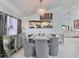 Elegant dining room with modern chandelier, table set with dinnerware, and natural light at 1309 Rebecca Dr, Haines City, FL 33844