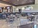 A spacious dining room with plenty of tables, chairs, and a full bar with mounted televisions at 1309 Rebecca Dr, Haines City, FL 33844