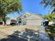 Charming single-story home featuring a well-manicured lawn, stone pathway, and attached two-car garage at 1309 Rebecca Dr, Haines City, FL 33844